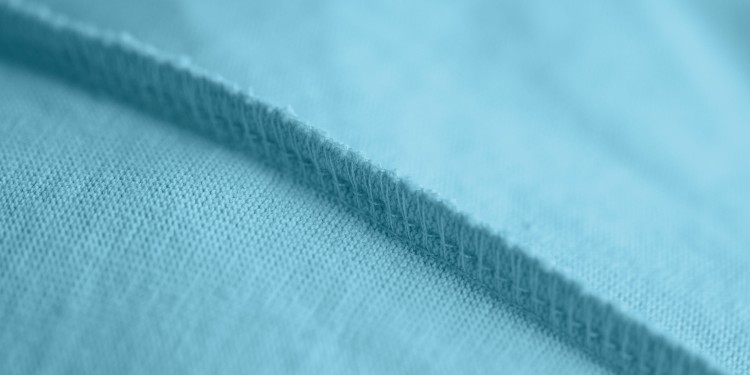 Close-up of an overlock seam on a blue fabric